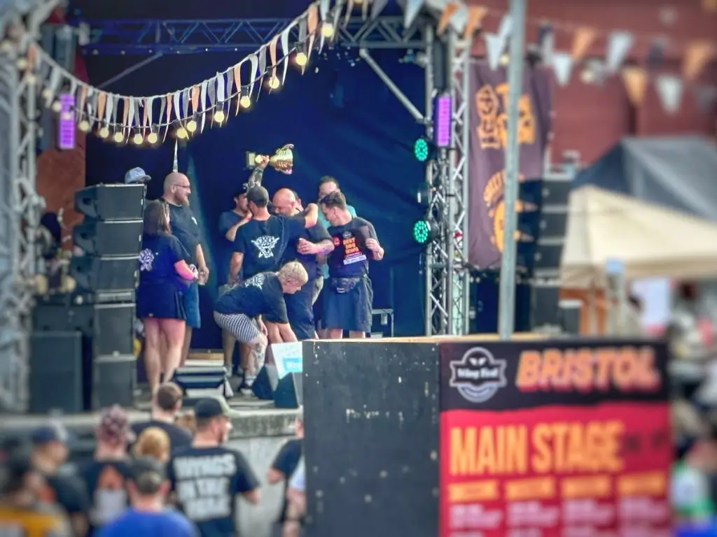 Wingfest champions holding up a trophy on the stage